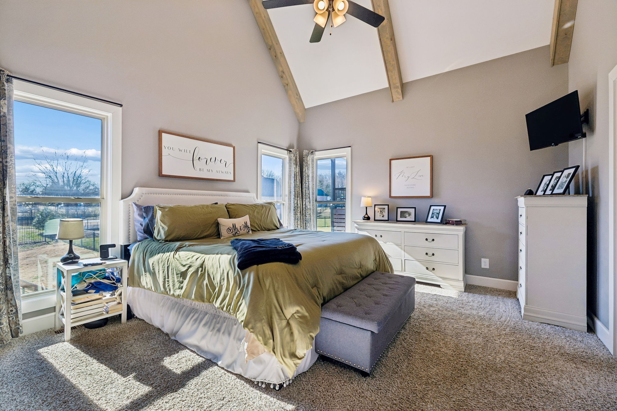 301 Timber Lane Lebanon, TN 37087 - Photo 29 of 74 a spacious bedroom with a bed a couch and a flat tv screen on the dresser