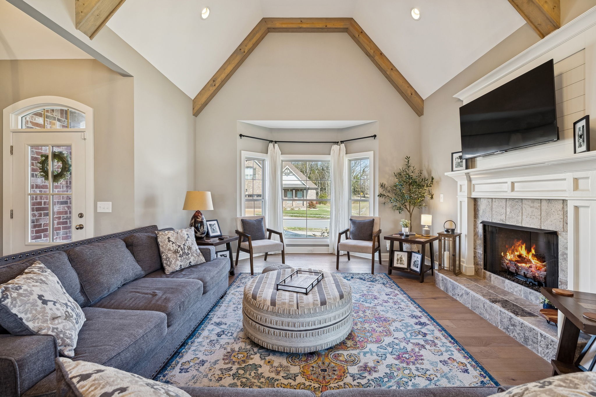 301 Timber Lane Lebanon, TN 37087 - Photo 10 of 74 a living room with furniture a fireplace and a flat screen tv