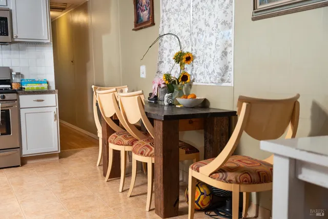 a utility room with dryer and furniture