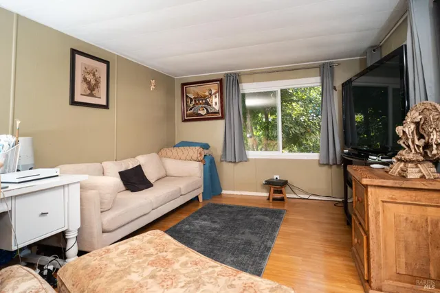 a living room with furniture and a lamp