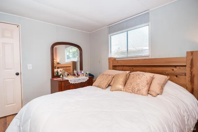 a bedroom with a bed and a large window