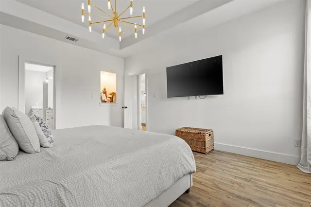 a bedroom with a bed and a flat screen tv