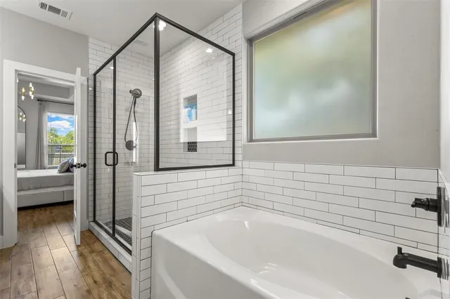 a bathroom with a bathtub and a shower