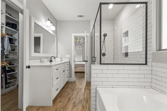 a bathroom with a tub sink and mirror