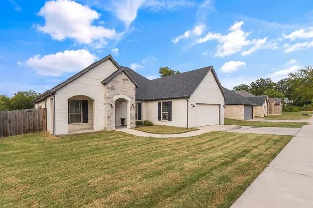 a big house with a big yard and large trees