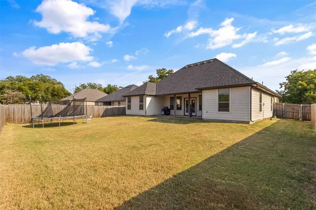 a front view of house with yard outdoor seating and barbeque oven