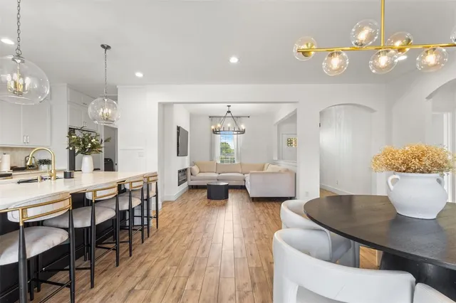 a view of a dining room with furniture and chandelier