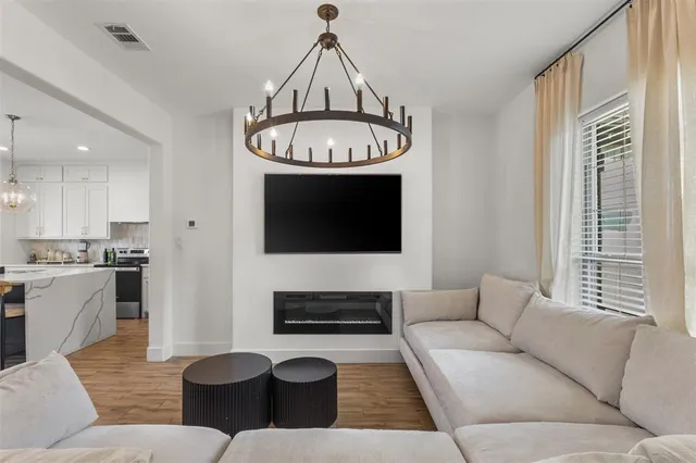 a living room with furniture and a chandelier