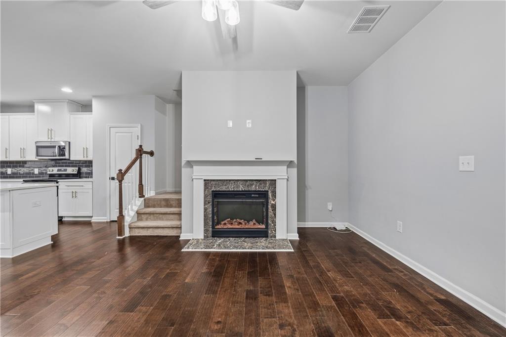 5038 Longview Walk Decatur, GA 30035 - Photo 11 of 25 a living room with wooden floors and a fireplace