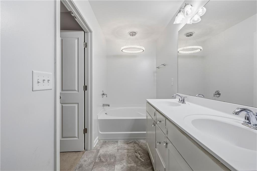 5038 Longview Walk Decatur, GA 30035 - Photo 16 of 25 a bathroom with a tub sink and mirror