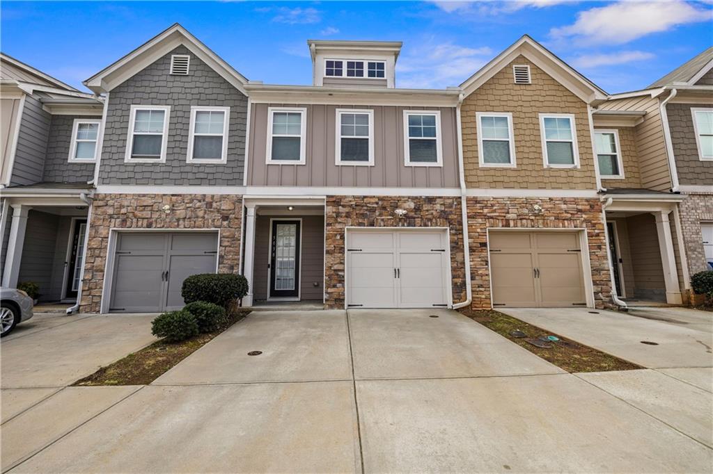 5038 Longview Walk Decatur, GA 30035 - Photo 2 of 25 a front view of a house with a yard and garage