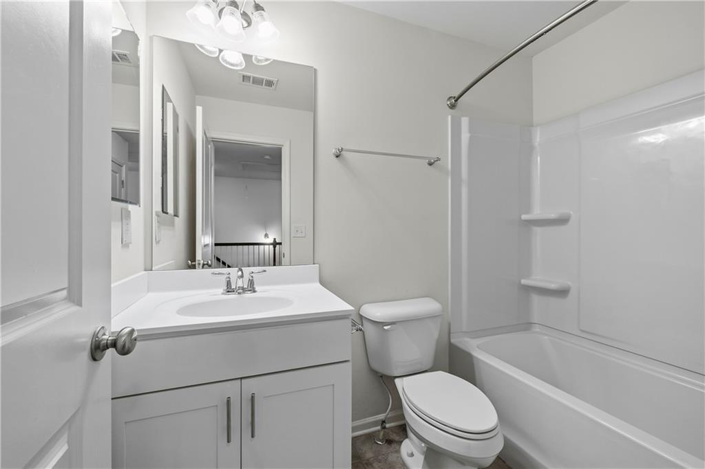 5038 Longview Walk Decatur, GA 30035 - Photo 23 of 25 a bathroom with a sink a toilet a mirror and shower