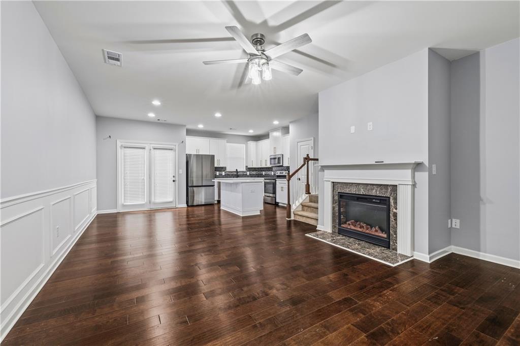 5038 Longview Walk Decatur, GA 30035 - Photo 4 of 25 a view of a livingroom with a fireplace a ceiling fan and a kitchen view