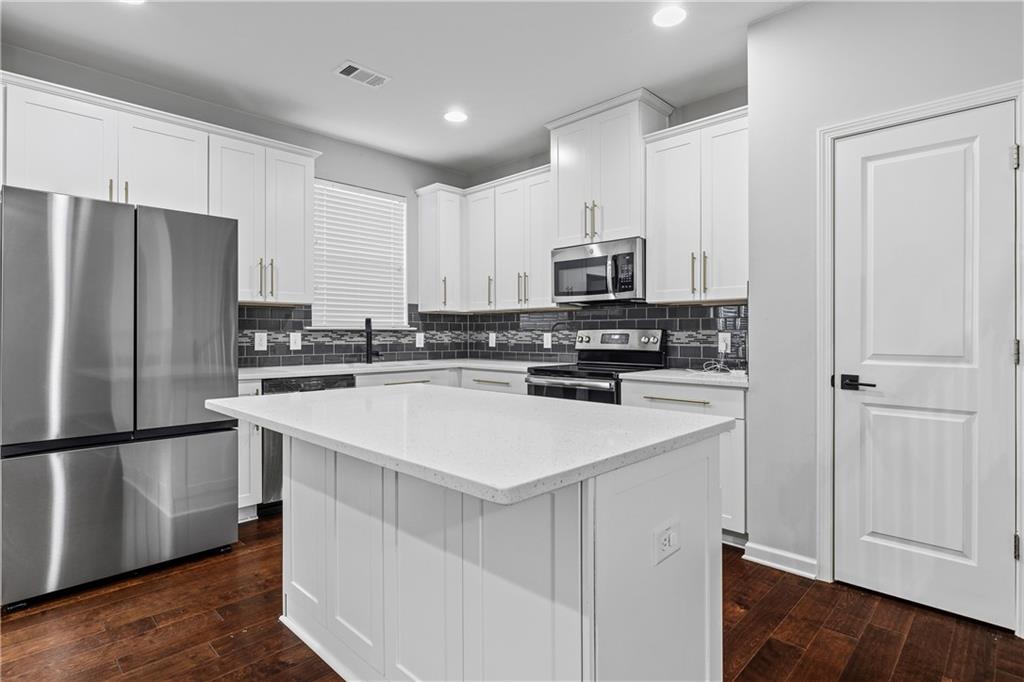 5038 Longview Walk Decatur, GA 30035 - Photo 9 of 25 a kitchen with appliances a sink and a refrigerator
