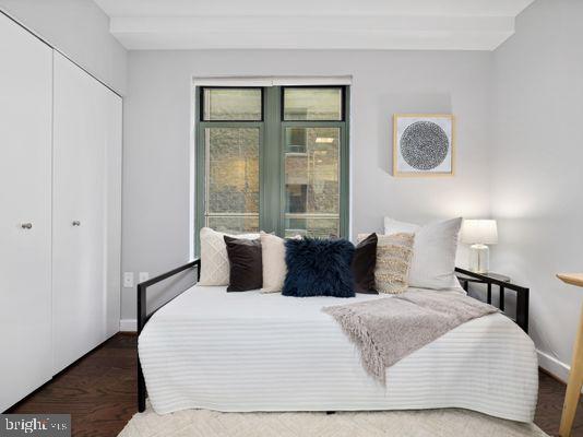 1150 K Street Northwest, Unit 709 Washington, DC 20005 - Photo 16 of 25 a bedroom with a large bed and a lamp next to a window