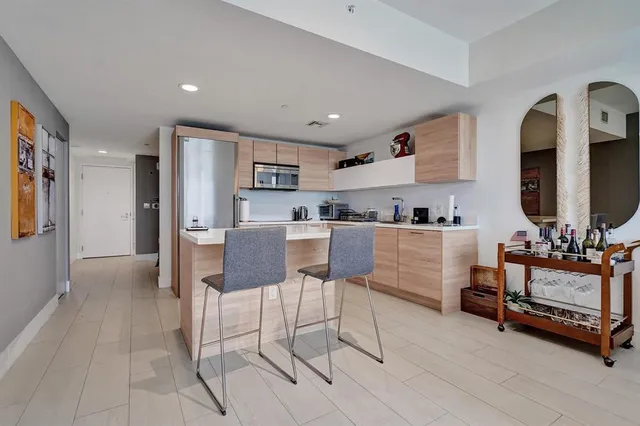 a living room with furniture and a kitchen view