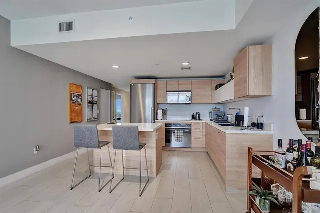a kitchen with cabinets and chair