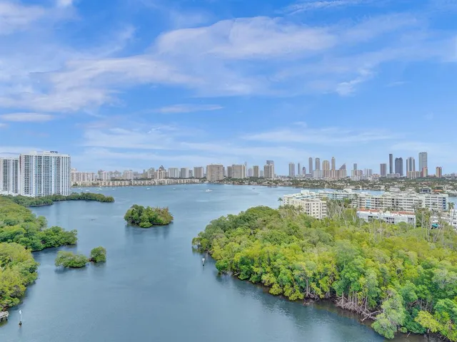 a view of a lake with houses in front of it