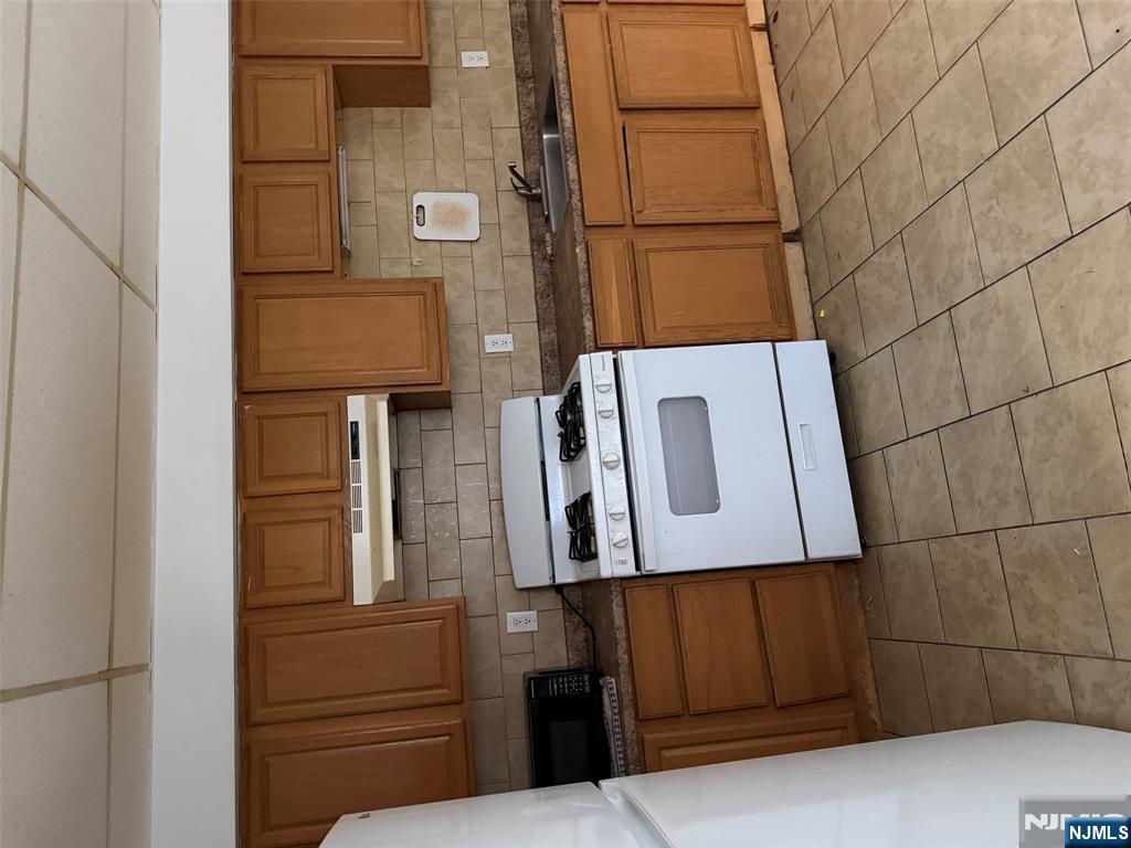 a kitchen with a stove sink and cabinets