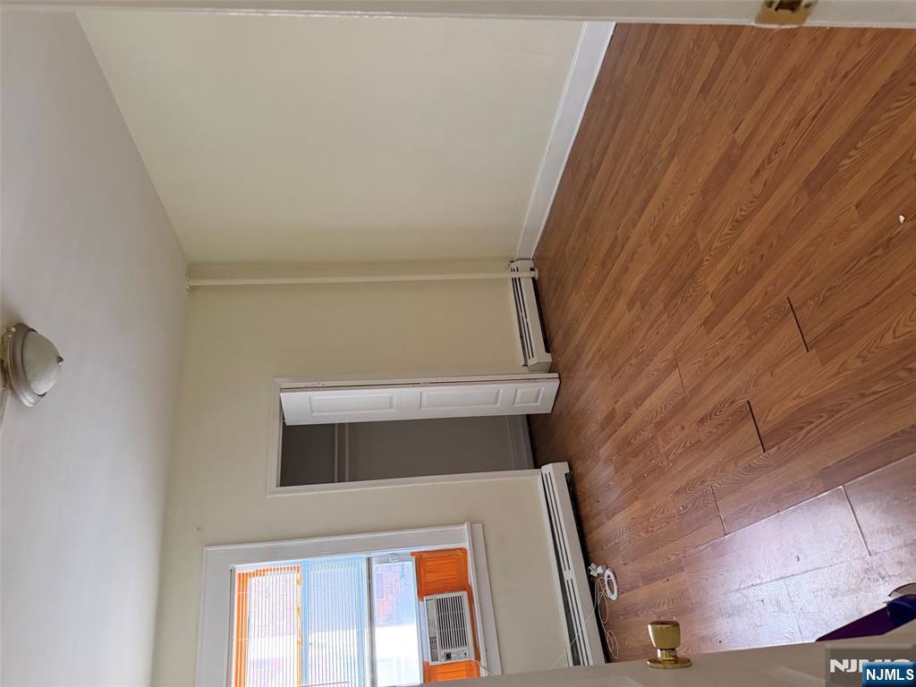 150 Park Avenue, Unit 1 East Rutherford, NJ 07073 - Photo 4 of 8 an empty room with wooden floor and windows