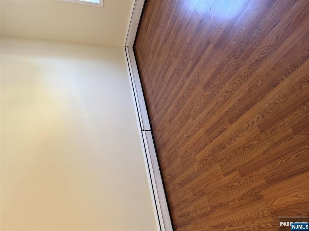 150 Park Avenue, Unit 1 East Rutherford, NJ 07073 - Photo 5 of 8 a view of an empty room with wooden floor