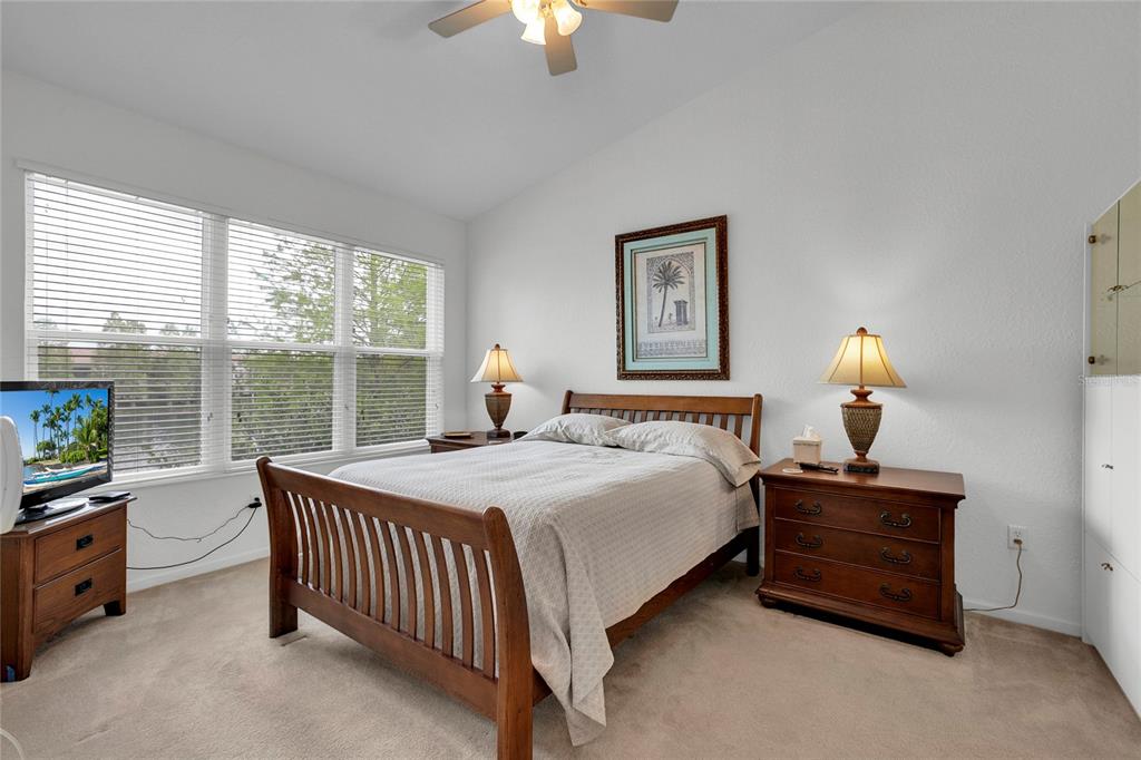 8310 Quimby Circle Davenport, FL 33896 - Photo 11 of 20 a bedroom with a bed and a chandelier