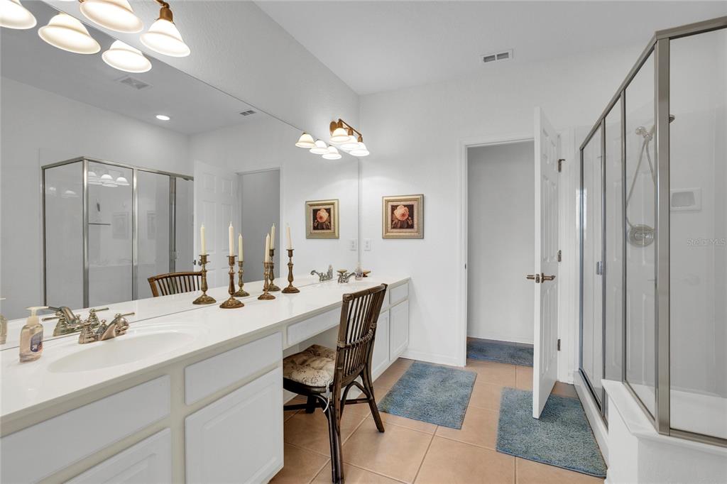 8310 Quimby Circle Davenport, FL 33896 - Photo 12 of 20 a bathroom with a sink double vanity granite and a mirror