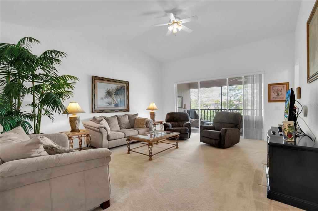 8310 Quimby Circle Davenport, FL 33896 - Photo 3 of 20 a living room with furniture a large window and a potted plant