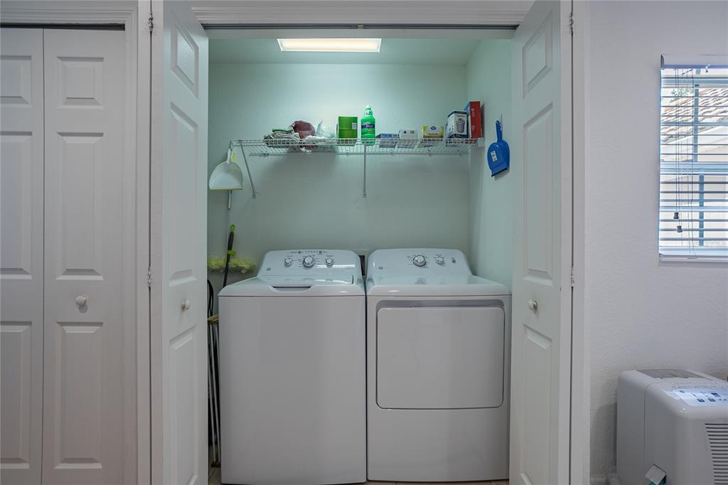 8310 Quimby Circle Davenport, FL 33896 - Photo 7 of 20 a utility room with dryer and washer
