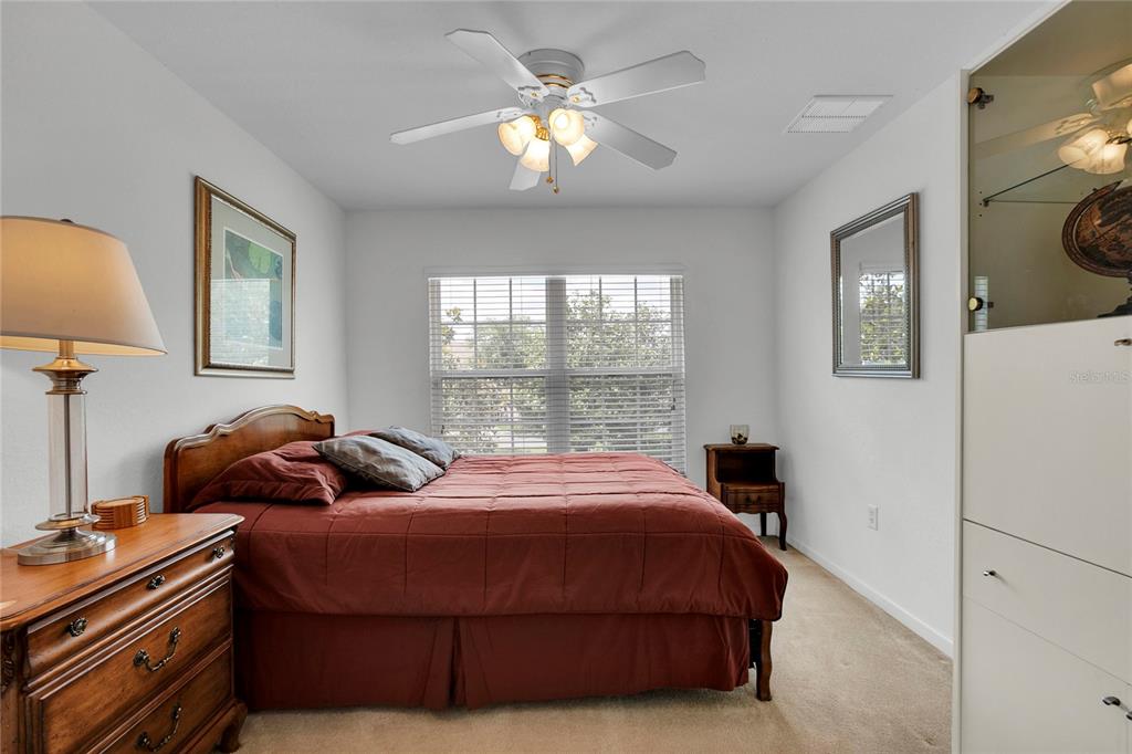 8310 Quimby Circle Davenport, FL 33896 - Photo 8 of 20 a bedroom with a bed and a chandelier