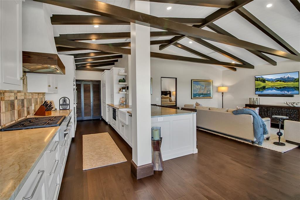 121 North Casey Key Road Osprey, FL 34229 - Photo 17 of 63 a view of living room kitchen with stainless steel appliances wooden floor and furniture