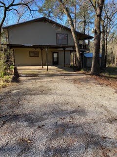 138 B Summer Place Huntsville, TX 77340 - Photo 1 of 17 a house with trees in the background