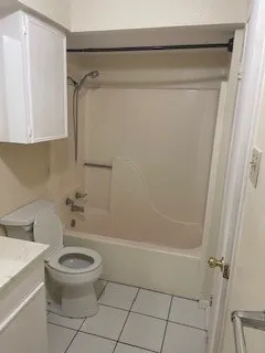 an empty room with a fireplace and windows