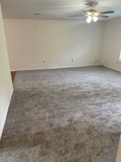 138 B Summer Place Huntsville, TX 77340 - Photo 14 of 17 an empty room with a chandelier fan and windows