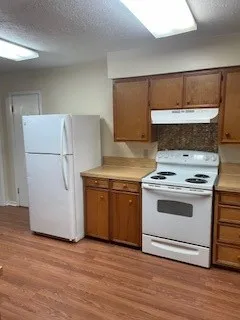 a kitchen with a stove and a refrigerator