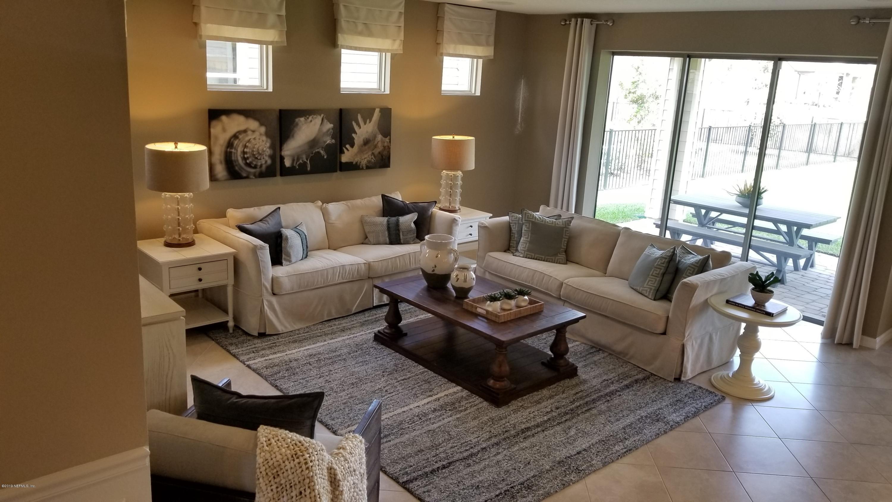 684 Broomsedge Circle St. Augustine, FL 32095 - Photo 2 of 7 a living room with furniture and a large window