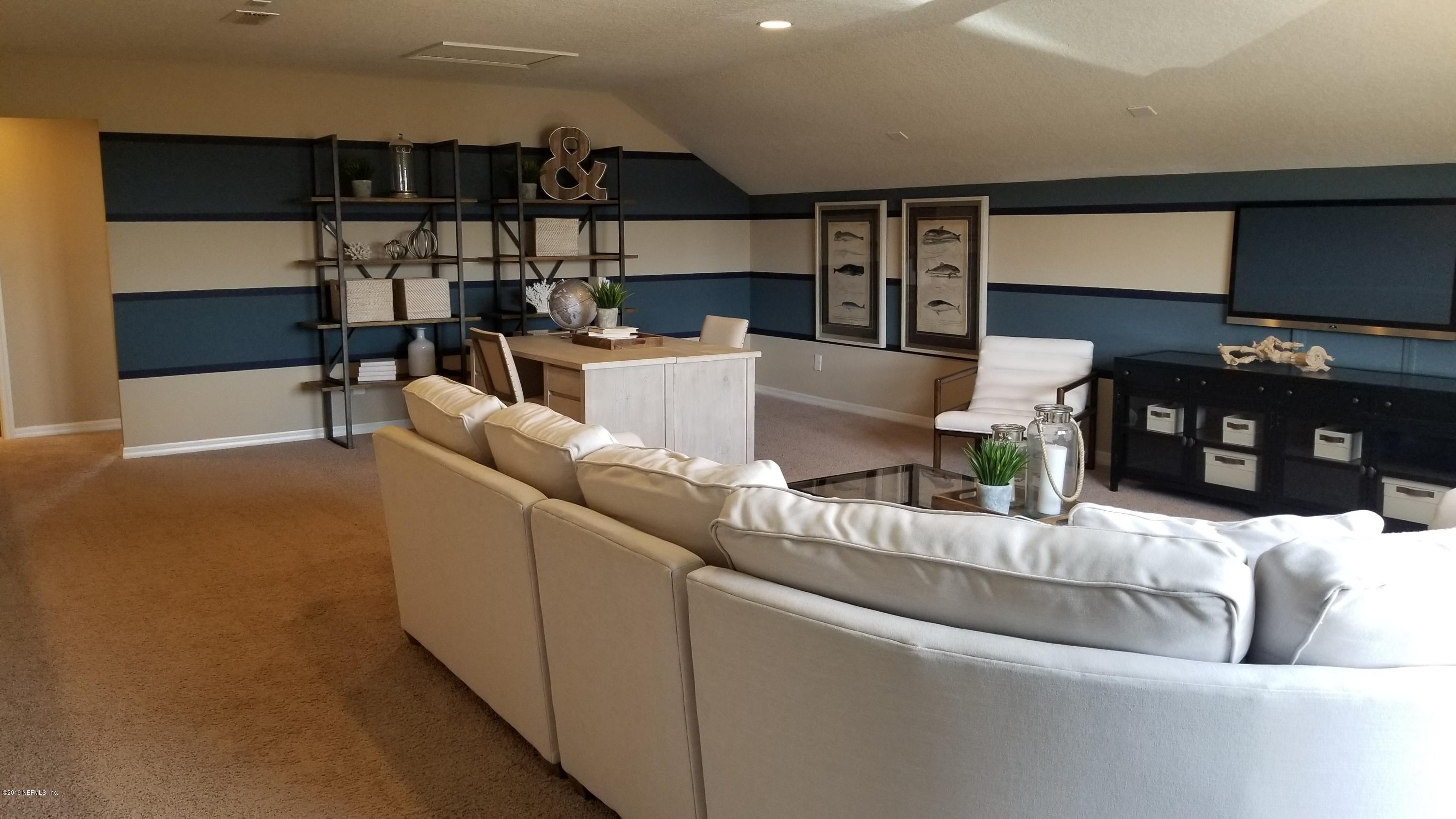 684 Broomsedge Circle St. Augustine, FL 32095 - Photo 3 of 7 a living room with furniture and a flat screen tv