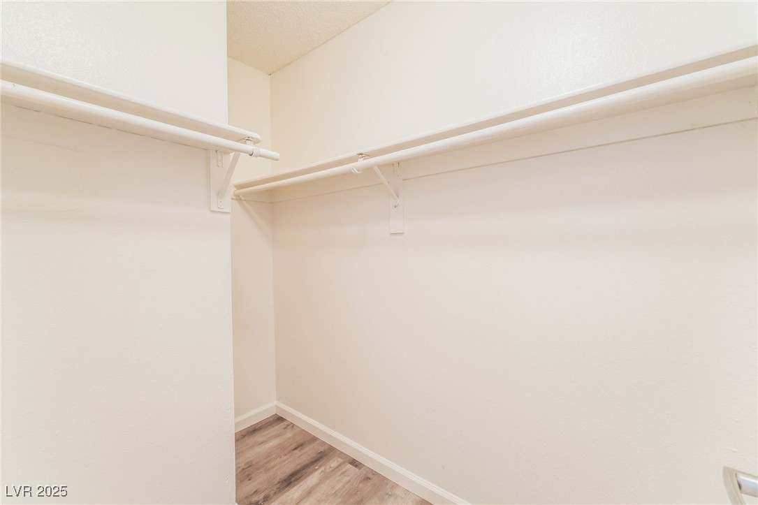 3151 North Soaring Gulls Drive, Unit 1083 Las Vegas, NV 89128 - Photo 18 of 45 Walk in closet featuring light wood-type flooring