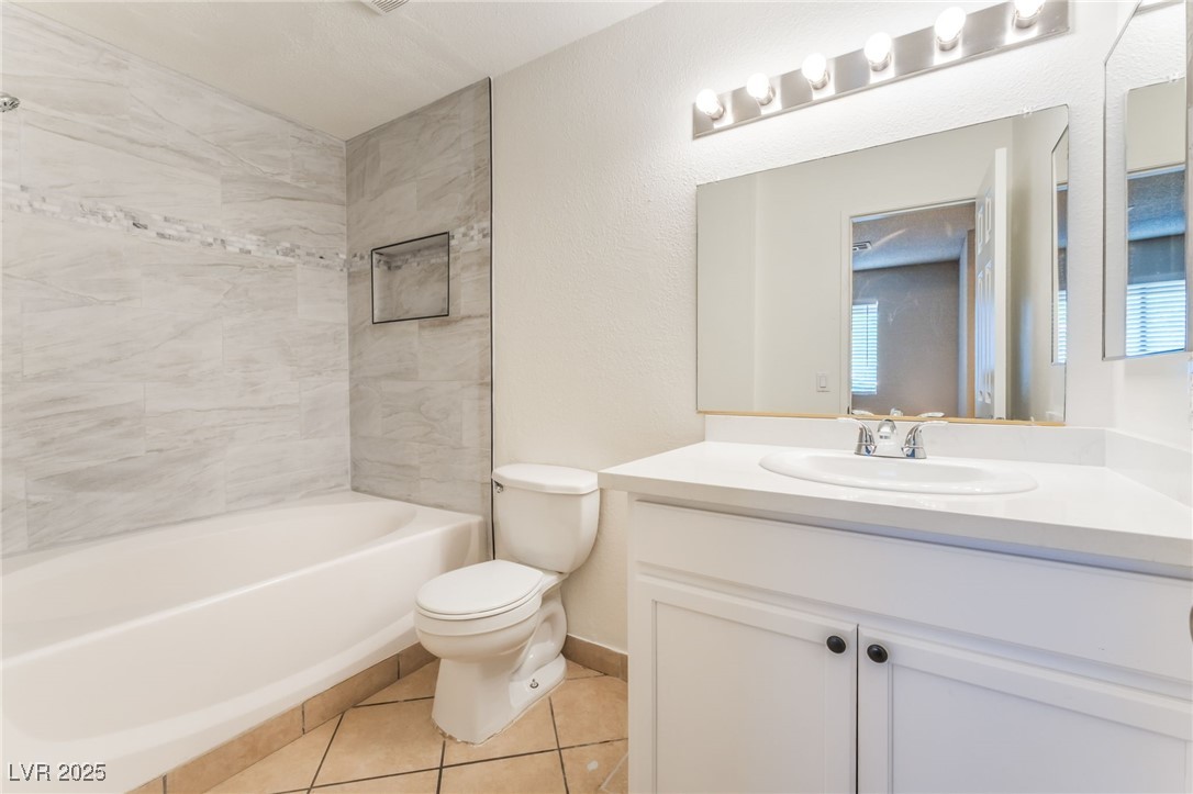 3151 North Soaring Gulls Drive, Unit 1083 Las Vegas, NV 89128 - Photo 19 of 45 Bathroom featuring vanity, shower / bath combination, and tile patterned floors