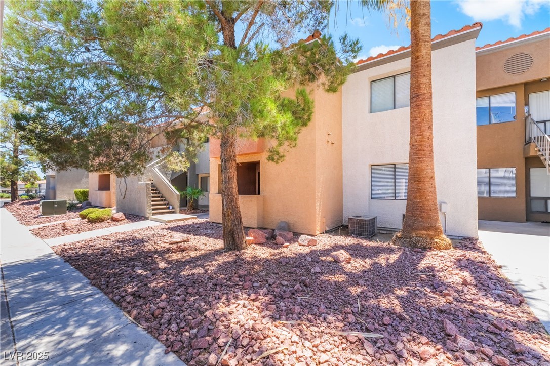 3151 North Soaring Gulls Drive, Unit 1083 Las Vegas, NV 89128 - Photo 29 of 45 View of building exterior featuring stairs