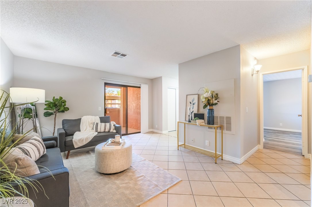 3151 North Soaring Gulls Drive, Unit 1083 Las Vegas, NV 89128 - Photo 3 of 45 Living area with a textured ceiling and light tile patterned floors