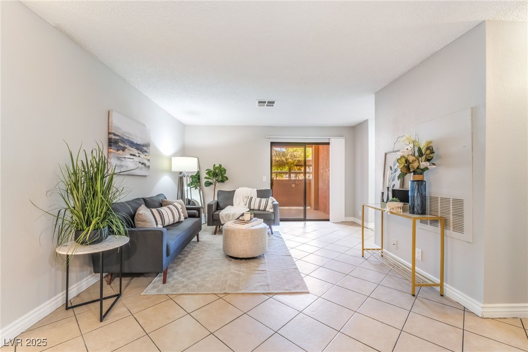 3151 North Soaring Gulls Drive, Unit 1083 Las Vegas, NV 89128 - Photo 7 of 45 Living area with light tile patterned floors and a textured ceiling