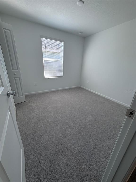 4741 Southwest 83rd Loop Ocala, FL 34476 - Photo 11 of 25 an empty room with windows