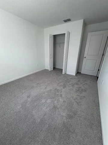 a view of an empty room and closet area