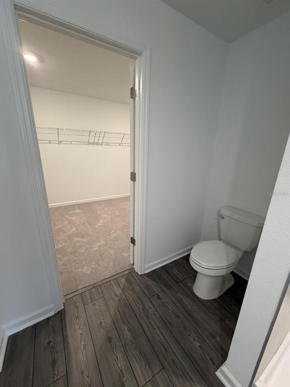 4741 Southwest 83rd Loop Ocala, FL 34476 - Photo 17 of 25 a bathroom with a granite countertop toilet and a sink