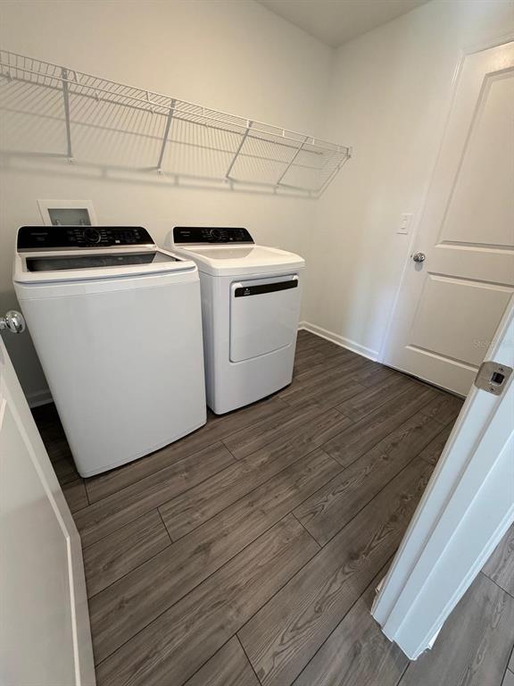 4741 Southwest 83rd Loop Ocala, FL 34476 - Photo 19 of 25 a view of a kitchen with wooden floor and white cabinets