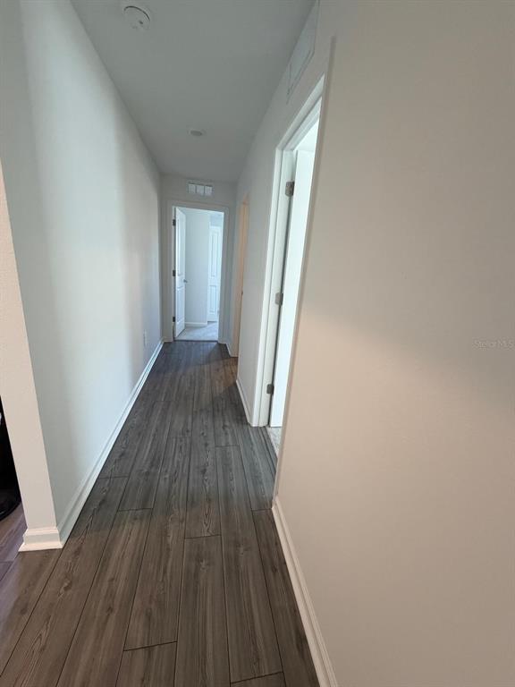 4741 Southwest 83rd Loop Ocala, FL 34476 - Photo 6 of 25 a view of a hallway with wooden floor