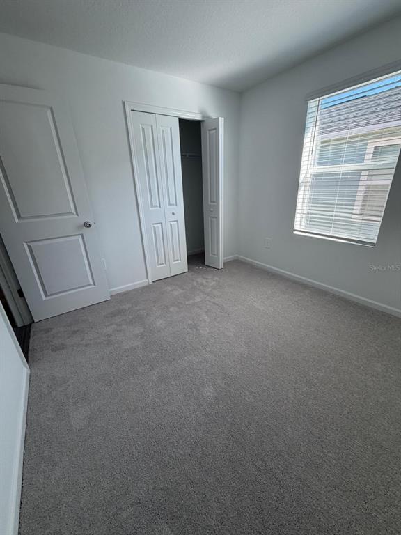 4741 Southwest 83rd Loop Ocala, FL 34476 - Photo 7 of 25 an empty room with windows