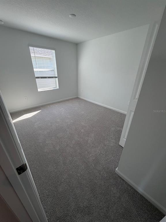 4741 Southwest 83rd Loop Ocala, FL 34476 - Photo 10 of 25 an empty room with windows