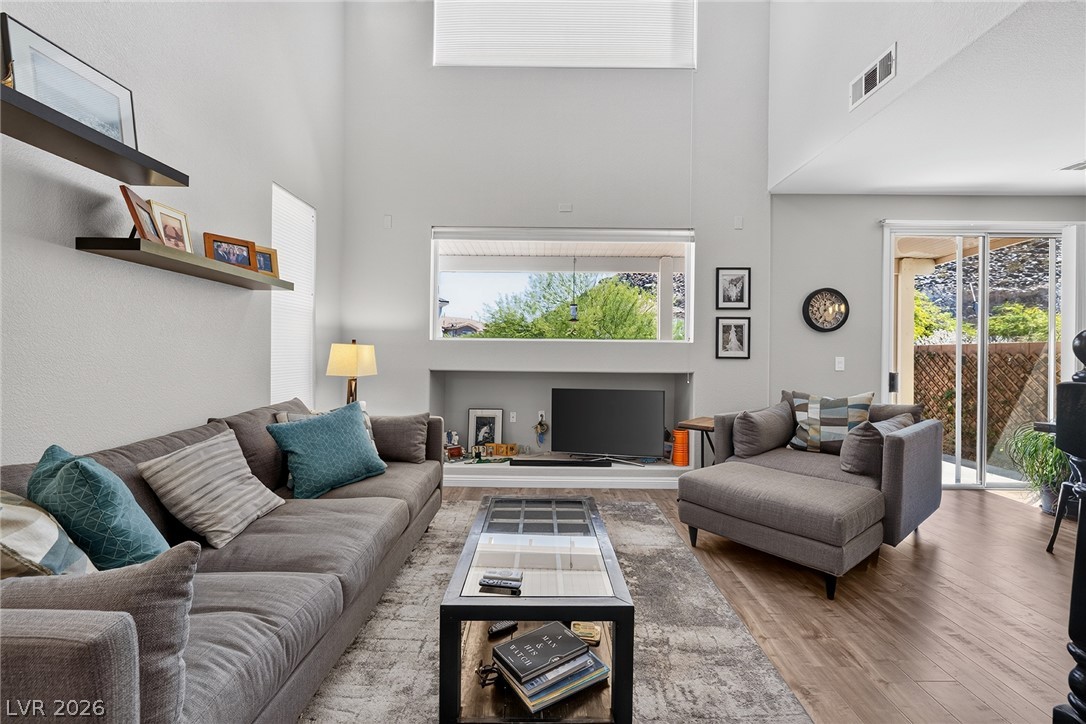 226 Priority Point Street Henderson, NV 89012 - Photo 9 of 32 Towering ceilings and sliding doors create a spacious living area ideal for relaxation.